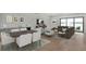 Bright living and dining area features wood floors, modern furniture, and access to a lake view at 2605 Waterfront Cir, Sarasota, FL 34240