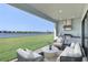 Covered outdoor kitchen with a grill, and seating overlooking the water at 2605 Waterfront Cir, Sarasota, FL 34240