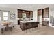 An expansive kitchen boasts dark wood cabinetry, a central island, and modern stainless steel appliances at 2625 Waterfront Cir, Sarasota, FL 34240