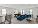 Bright living area featuring modern décor, a pool table, and a comfortable blue sectional sofa at 2625 Waterfront Cir, Sarasota, FL 34240