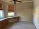 Spacious living room with large windows, ceiling fan, and decorative wallpaper at 2910 122Nd E Ter, Parrish, FL 34219