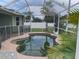 Screened-in pool with lush landscaping in the background at 2910 122Nd E Ter, Parrish, FL 34219