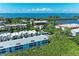 Beautiful aerial view of a condo community, with a pool, and lush green vegetation at 3607 E Bay Dr # 202, Holmes Beach, FL 34217