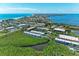 Breathtaking aerial view showcasing coastal homes near the ocean with tropical foliage and stunning water views at 3607 E Bay Dr # 202, Holmes Beach, FL 34217