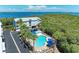 Aerial view of a community building with a pool surrounded by trees, offering a peaceful and serene environment at 3607 E Bay Dr # 202, Holmes Beach, FL 34217