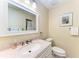 Bathroom featuring a vanity with a single sink, a toilet, and a framed mirror at 3607 E Bay Dr # 202, Holmes Beach, FL 34217