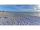 Expansive beach with soft sand and calm waves under a clear blue sky, providing a serene coastal experience at 3607 E Bay Dr # 202, Holmes Beach, FL 34217