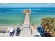 Charming beach pier with a two-story building at the end, offering stunning views of the surrounding turquoise waters at 3607 E Bay Dr # 202, Holmes Beach, FL 34217