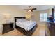 Serene bedroom with a comfortable bed, stylish furnishings, and ample natural light from the window at 3607 E Bay Dr # 202, Holmes Beach, FL 34217