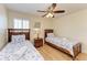 Comfortable bedroom featuring two twin beds with nautical-themed bedding and a ceiling fan at 3607 E Bay Dr # 202, Holmes Beach, FL 34217