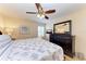 Inviting bedroom featuring a comfortable bed, dark wood furniture, and a relaxing ambiance with natural light at 3607 E Bay Dr # 202, Holmes Beach, FL 34217