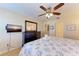 Bright bedroom with a ceiling fan, dresser, and a flat-screen TV for comfortable relaxation at 3607 E Bay Dr # 202, Holmes Beach, FL 34217