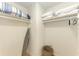 Closet with shelving for storage, including an ironing board and wicker basket at 3607 E Bay Dr # 202, Holmes Beach, FL 34217