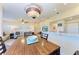 Inviting dining room featuring a wooden table and a lovely light fixture, complemented by a comfortable living area at 3607 E Bay Dr # 202, Holmes Beach, FL 34217
