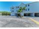 View of a condo building with covered parking and easy access at 3607 E Bay Dr # 202, Holmes Beach, FL 34217