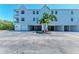 Exterior view of a condo building with covered parking at 3607 E Bay Dr # 202, Holmes Beach, FL 34217