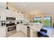 Well-equipped kitchen with stainless steel appliances, granite countertops, breakfast bar, and lovely outdoor views at 3607 E Bay Dr # 202, Holmes Beach, FL 34217