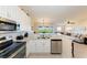 Open kitchen showcases granite counters, stainless appliances, a breakfast bar, and seamless access to the living area at 3607 E Bay Dr # 202, Holmes Beach, FL 34217