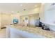 Bright kitchen with granite countertops, stainless steel appliances, and an open layout, perfect for entertaining at 3607 E Bay Dr # 202, Holmes Beach, FL 34217