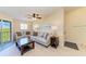 Comfortable living room with neutral tones, tile floors, and access to a balcony at 3607 E Bay Dr # 202, Holmes Beach, FL 34217