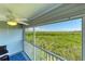 Screened-in patio with nature views, a ceiling fan, and comfortable seating at 3607 E Bay Dr # 202, Holmes Beach, FL 34217