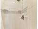 Up-close shower with new white tiles and light-blue decorative tiles at 3607 E Bay Dr # 202, Holmes Beach, FL 34217