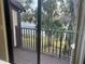 Private balcony with railing offering views of lush landscaping and natural scenery at 4022 Beaver Ln # 1000G, Port Charlotte, FL 33952
