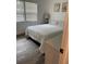Bright bedroom featuring two large windows, wood-look floors, and neutral decor at 4022 Beaver Ln # 1000G, Port Charlotte, FL 33952