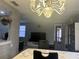 Dining room featuring a stylish chandelier and a view into the spacious living room at 4022 Beaver Ln # 1000G, Port Charlotte, FL 33952