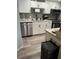 Modern kitchen featuring white cabinets, stainless steel appliances, and a tiled backsplash at 4022 Beaver Ln # 1000G, Port Charlotte, FL 33952