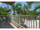 Private balcony with outdoor seating and tropical views at 4805 2Nd Ave, Holmes Beach, FL 34217