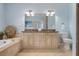 Elegant bathroom with double vanity, granite countertop, and a large mirror at 4805 2Nd Ave, Holmes Beach, FL 34217