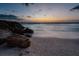 Rocky shoreline and ocean at sunset, tranquil beach scene at 4805 2Nd Ave, Holmes Beach, FL 34217