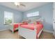 Guest bedroom with two twin beds and light coral bedding at 4805 2Nd Ave, Holmes Beach, FL 34217