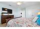 Primary bedroom with queen bed and TV at 4805 2Nd Ave, Holmes Beach, FL 34217