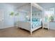 Bright bedroom featuring a comfortable four-poster bed and coastal decor at 4805 2Nd Ave, Holmes Beach, FL 34217