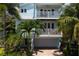 Aerial view of a two-story light blue house with lush landscaping at 4805 2Nd Ave, Holmes Beach, FL 34217