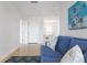 Light and airy hallway with tile flooring and blue sofa at 4805 2Nd Ave, Holmes Beach, FL 34217