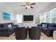 Relaxing living room featuring two sofas and a large TV at 4805 2Nd Ave, Holmes Beach, FL 34217