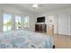 Main bedroom with king bed, TV, and ensuite bathroom access at 4805 2Nd Ave, Holmes Beach, FL 34217