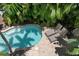 Aerial view of a kidney-shaped pool with lounge chairs at 4805 2Nd Ave, Holmes Beach, FL 34217