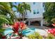 View of the refreshing pool area with tropical plants and lounge chairs at 4805 2Nd Ave, Holmes Beach, FL 34217