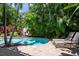 Relaxing pool area with lounge chairs and lush tropical landscaping at 4805 2Nd Ave, Holmes Beach, FL 34217