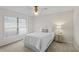 Cozy bedroom with a neutral palette, featuring a double bed and a nightstand with a table lamp at 4714 Elder Berry Dr, Sarasota, FL 34241