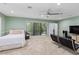 Comfortable bedroom with a large window, ceiling fan, and neutral color palette at 4714 Elder Berry Dr, Sarasota, FL 34241