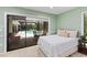 Relaxing bedroom with pool access through sliding glass doors and a view of the screened-in pool area at 4714 Elder Berry Dr, Sarasota, FL 34241