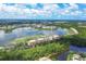 Aerial view of a lakefront community with lush landscaping and modern buildings at 6438 Watercrest Way # 204, Lakewood Ranch, FL 34202