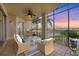 Spacious balcony with furniture and stunning sunset views over the lake at 6438 Watercrest Way # 204, Lakewood Ranch, FL 34202