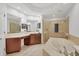Spa-like bathroom with double vanities, a soaking tub, and a separate shower at 6438 Watercrest Way # 204, Lakewood Ranch, FL 34202