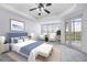 Main bedroom with a king-size bed, two armchairs, and access to a balcony at 6438 Watercrest Way # 204, Lakewood Ranch, FL 34202